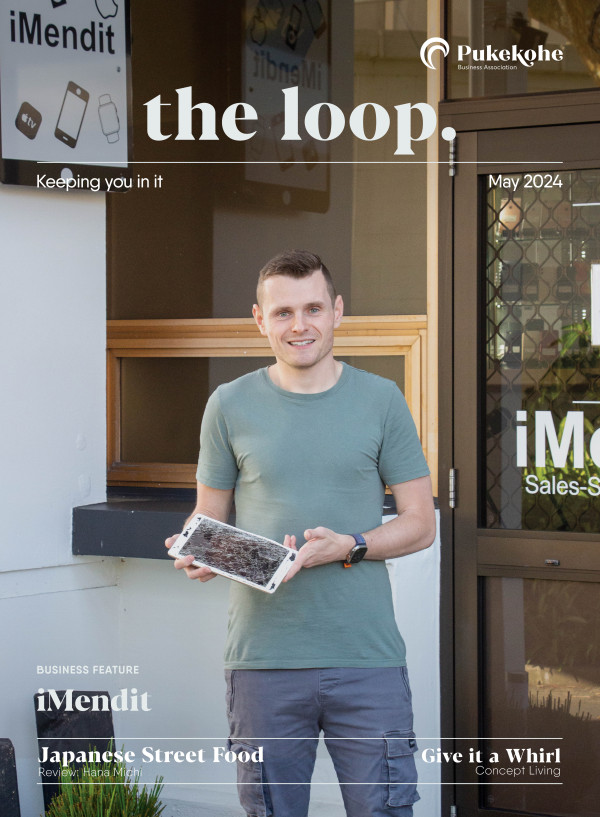 Matt Hurley holding a broken Ipad in front of his Pukekohe Store, iMendit